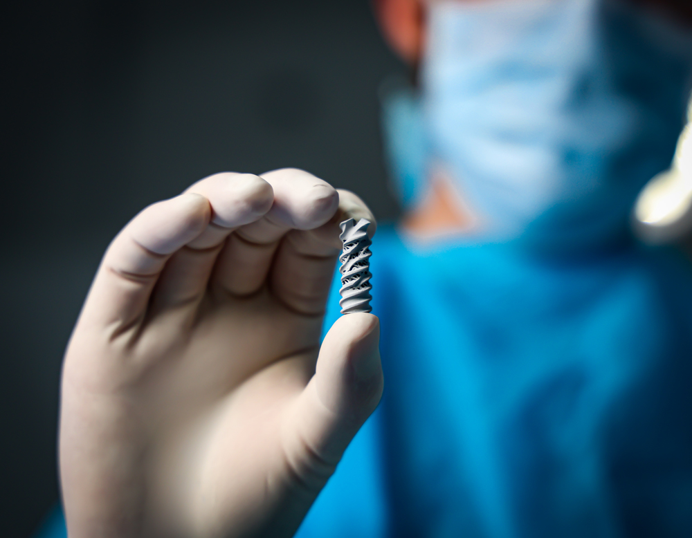 Surgeon holding the Patriot SI implant by Spinal Simplicity